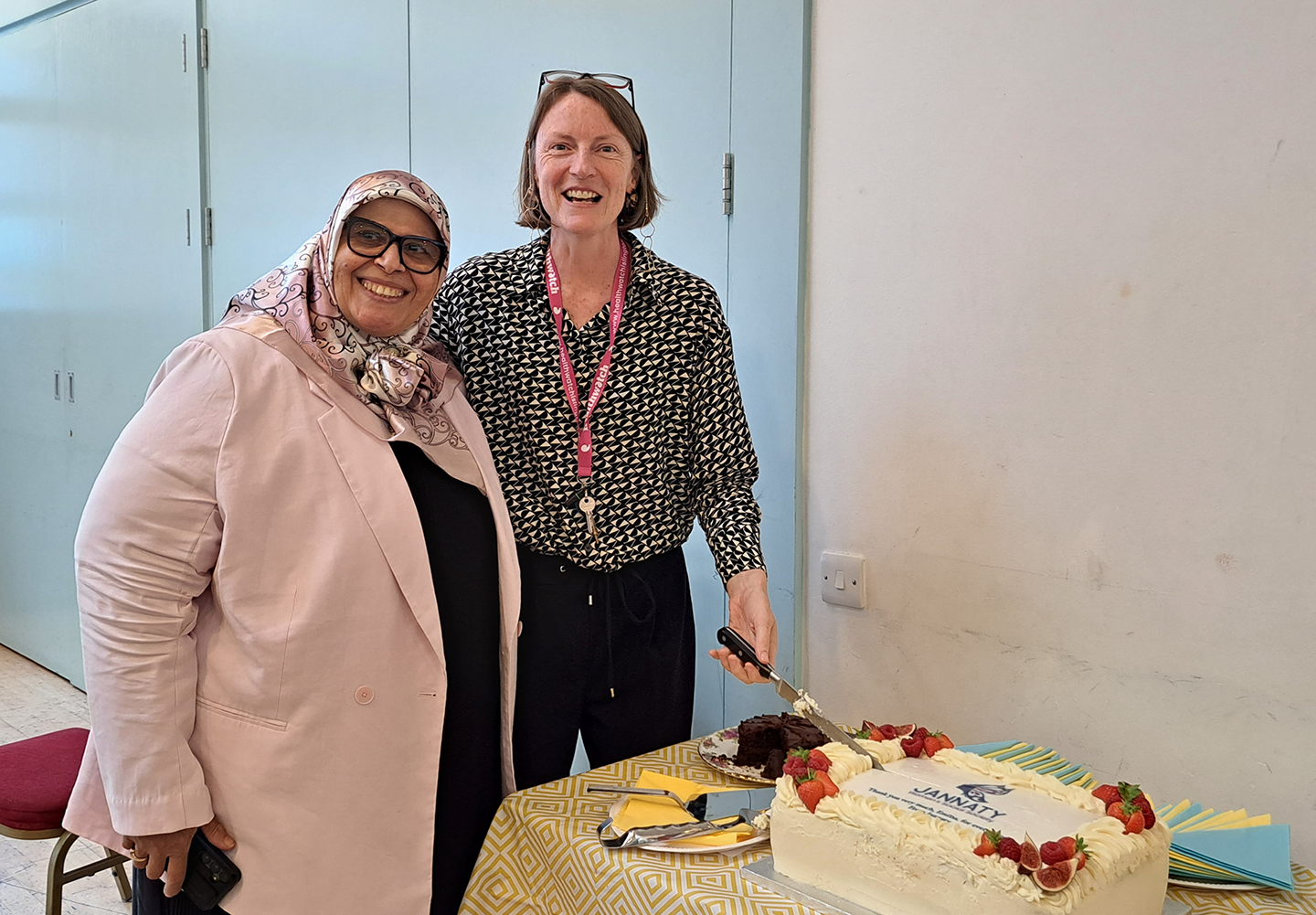 Majida Sayam (left) from Jannaty with outgoing Healthwatch Islington chief executive Emma Whitby and a cake