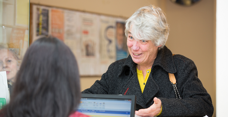 Woman at GP desk