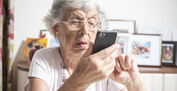 Older woman trying to use e-consult on her phone