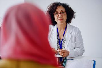Female gynaecologist talking to her patient about cervical cancer awareness