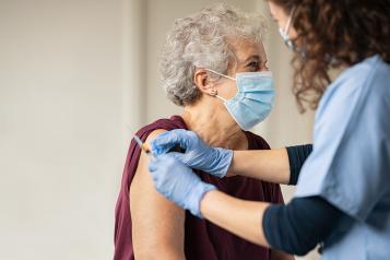 Older woman receiving a covid vaccination